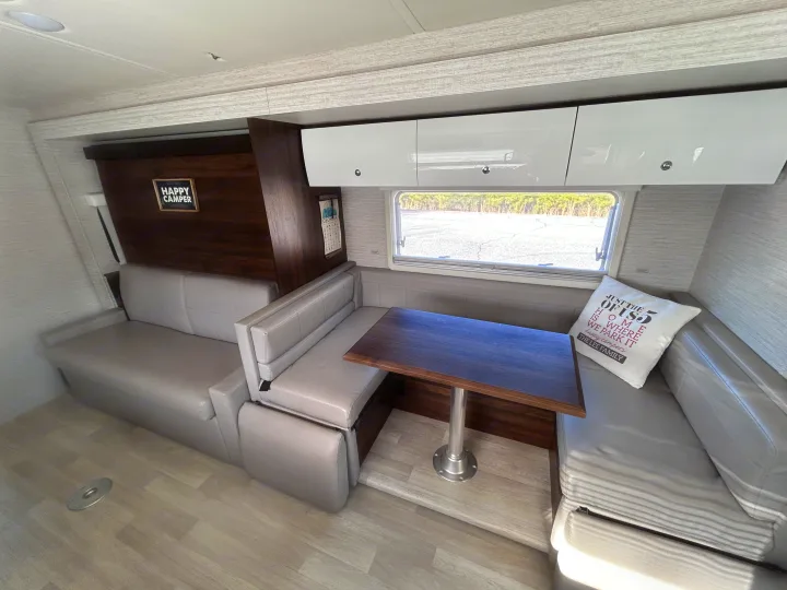 U shaped Dinette that also turns into bed in addition to the over head bunk.. Winnebago Navion 2022