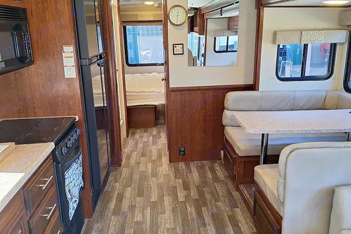 Spacious RV rental interior with a full kitchen, dinette seating, and separate bedroom visible.. FR3 FR3 Motorhome 2018