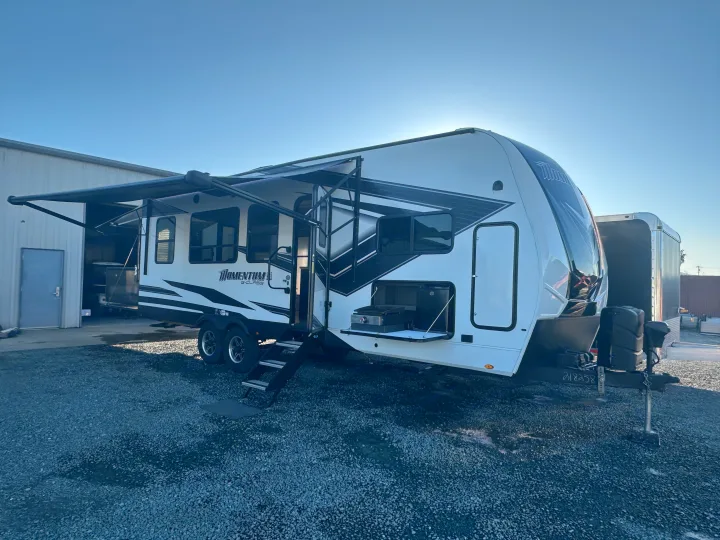 Momentum G-Class RV rental with extended awnings and an outdoor kitchen, ready for your next adventure.. Grand Design Momentum 2022