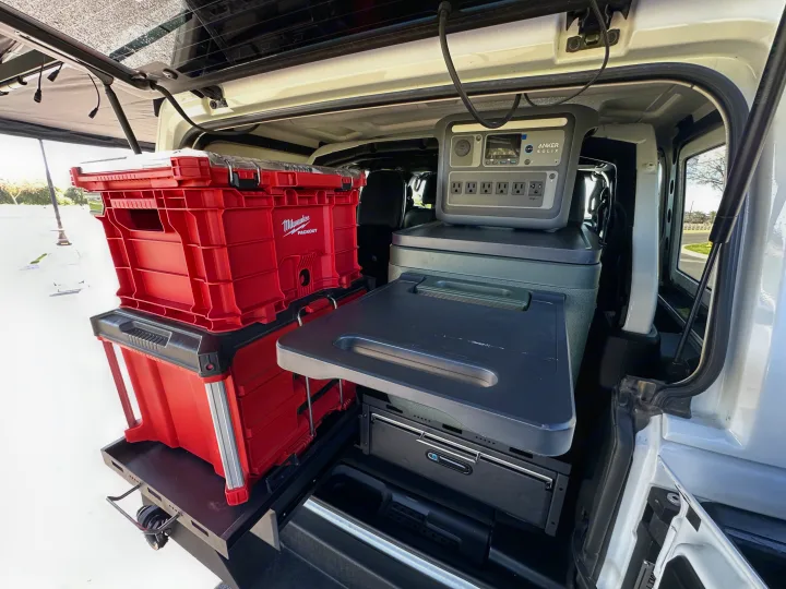 RV rental: organized vehicle setup with Milwaukee PACKOUT storage, Anker SOLIX portable power, & cooler for adventures.. Jeep Overlander 2019