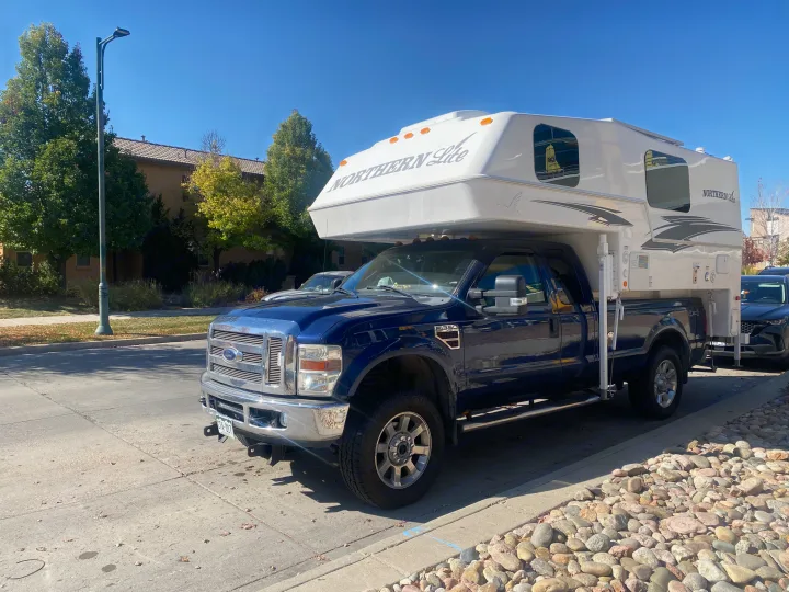 Blue Ford F-350 with a Northern Lite truck camper, ready for your next RV rental outdoor adventure.. Northern Lite 9-6 Wet Bath 2022