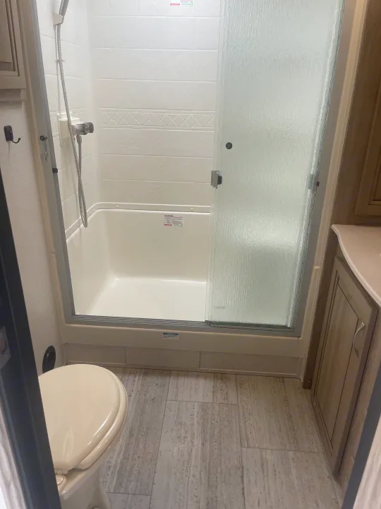 RV rental: Compact RV bathroom with shower, toilet, and vanity area. Ideal for your next camper adventure.. Palomino Solaire Ultra Lite 2020