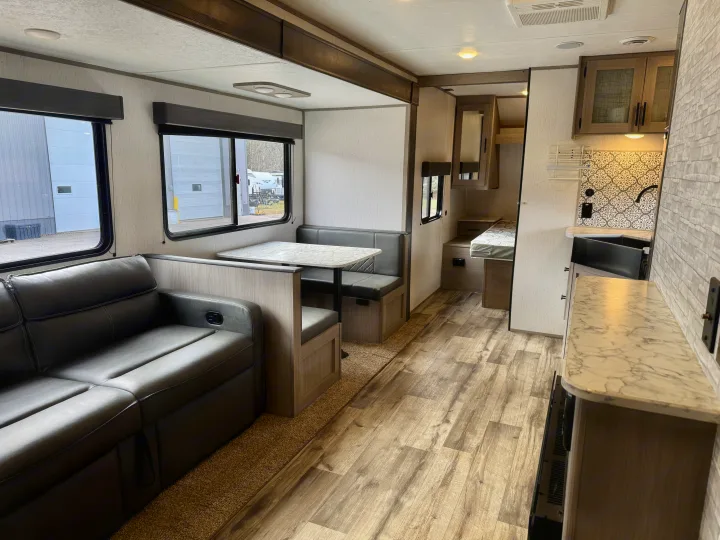 Spacious, modern RV rental interior: a bright living area with sofa, dinette, and equipped kitchen.. Coleman Lantern 2022