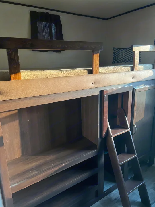 RV rental interior featuring cozy bunk beds with built-in storage and a pull-out ladder.. Jayco Jay Flight 2018