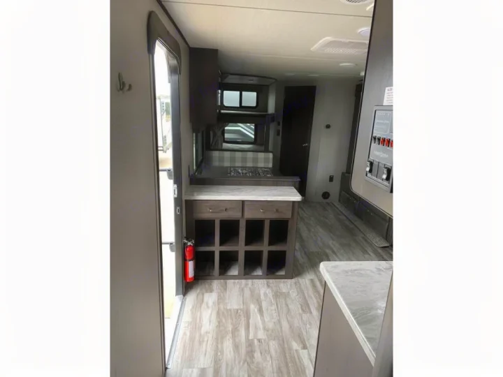 This RV rental interior features a kitchen, dining booth, and control panel. Fire extinguisher by the door.. Grand Design Transcend Xplor 2020