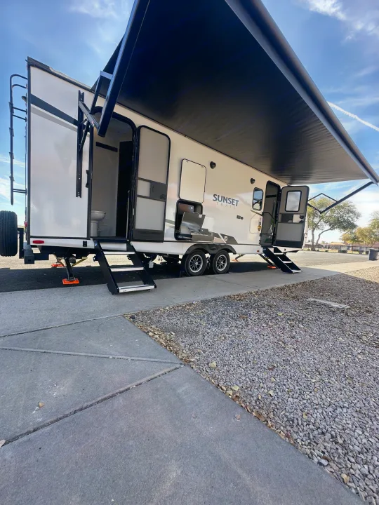 RV rental: This Sunset Trail travel trailer boasts an extended awning, outdoor kitchen, and bathroom setup for adventure.. Keystone RV Sunset Trail 2024