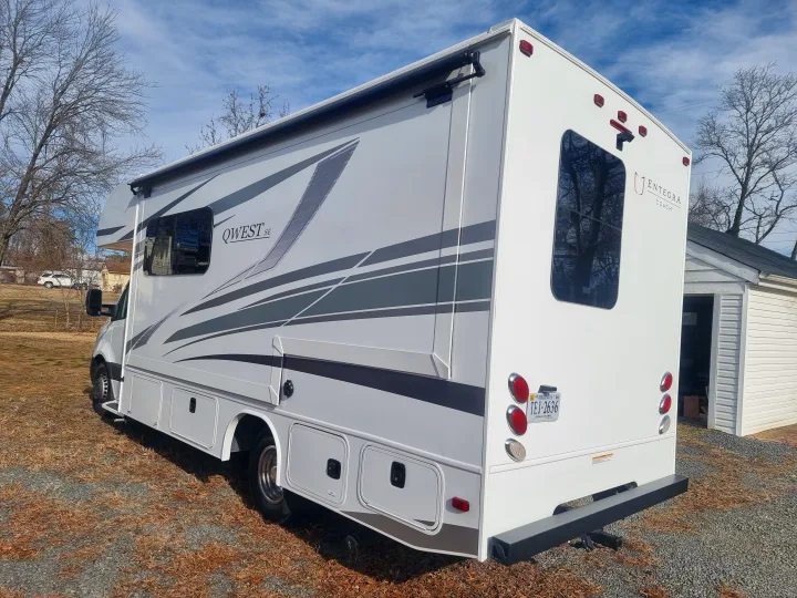 A clean, white Entegra Coach Qwest SE Class C RV rental is parked on gravel under a blue sky.. Entegra Qwest SE 2025 Qwest 2025 Mercdes-Benz 2025