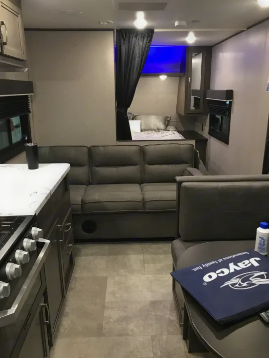Tour this comfy rv rental with a large sectional sofa, kitchen, and private bedroom with blue lights.. Jayco Jay Flight SLX 2020