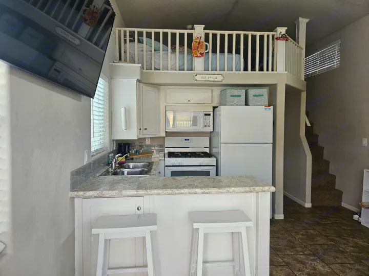 Experience this cozy RV rental with a compact kitchen, stairs to a loft bedroom, and smart use of space.. ATHMS CCHPT 2019