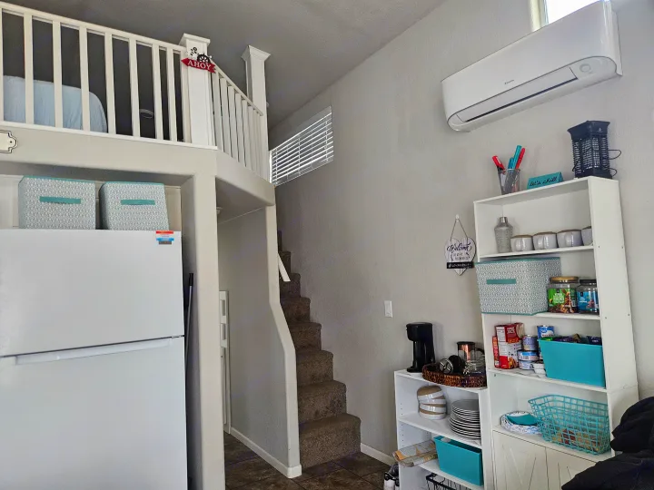 An RV rental's smart use of space: loft bedroom, full-size fridge, staircase, and organized kitchen/storage.. ATHMS CCHPT 2019