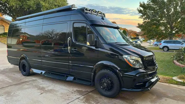 This sleek black Mercedes-Benz Sprinter camper van, customized with roof lights, is ideal for RV rental adventures.. Midwest Automotive Designs Midwest Automotive Designs Class B 2016