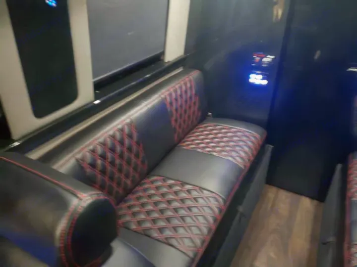 Experience comfort in this RV rental's interior, featuring luxurious black leather seating with red diamond stitching.. Midwest Automotive Designs Midwest Automotive Designs Class B 2016