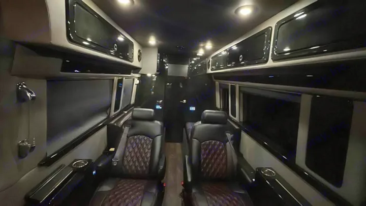 Luxurious RV rental interior: plush, diamond-stitched captain's chairs, ample overhead storage, and ambient lighting for comfort.. Midwest Automotive Designs Midwest Automotive Designs Class B 2016