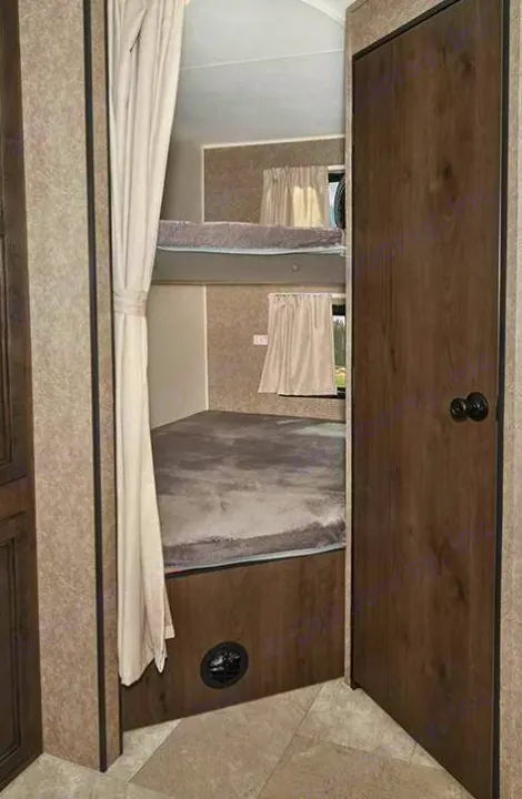 RV rental: Bunk beds with curtains and windows offer a cozy sleeping area inside this camper for an adventurous family.. Starcraft Autumn Ridge 2022