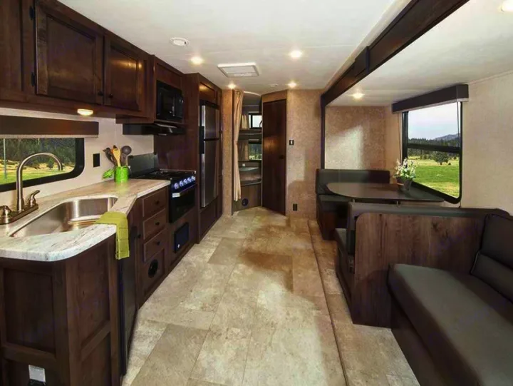 Spacious RV rental interior featuring a full kitchen, dinette, and sofa. Enjoy home comforts on the road.. Starcraft Autumn Ridge 2022