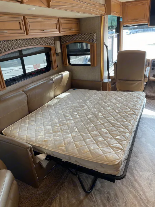 Explore this RV rental's versatile interior featuring a pull-out mattress from the couch, sleek cabinetry, and driver's area.. Canyon Star Canyon Star Motorhome 2020