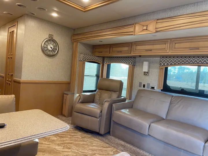 Spacious RV rental interior with comfortable leather recliners, sofa, and dining area. Enjoy modern living on the go.. Canyon Star Canyon Star Motorhome 2020