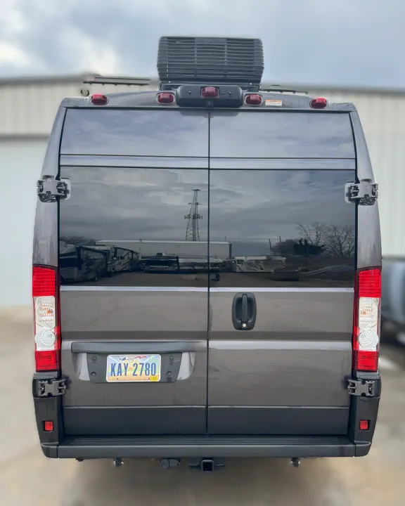 Rear view of a grey camper van, an ideal RV rental, with Ohio plate, roof AC, and hitch. Ready for adventure!. Winnebago Solis 2021