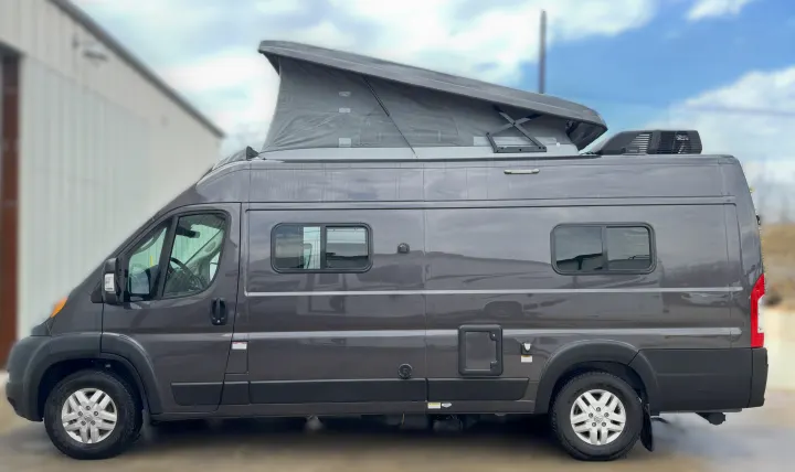 This gray pop-top camper van is ready for your next RV rental adventure, offering a compact and versatile travel experience.. Winnebago Solis 2021