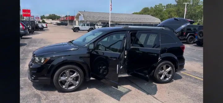 Black SUV with open doors & trunk on a dealer lot. Explore spacious vehicles like this, or an RV rental for your. Dodge Journey 2016