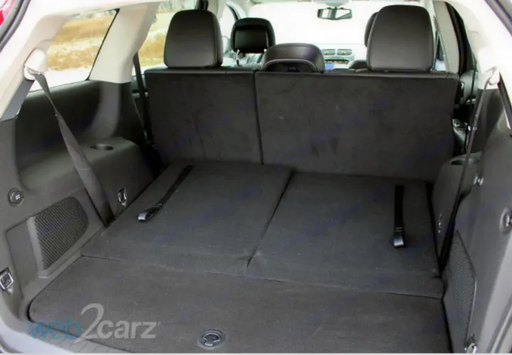 Spacious SUV rear with folded seats for ample cargo, offering ideal storage for an RV rental adventure.. Dodge Journey 2016