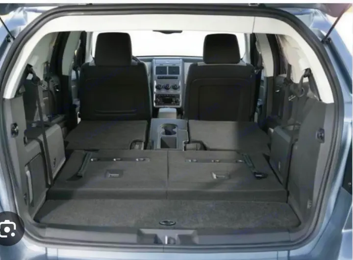 Vehicle's rear cargo area with seats folded flat for maximum storage. Ideal for packing gear for an RV rental trip or road travel.. Dodge Journey 2016