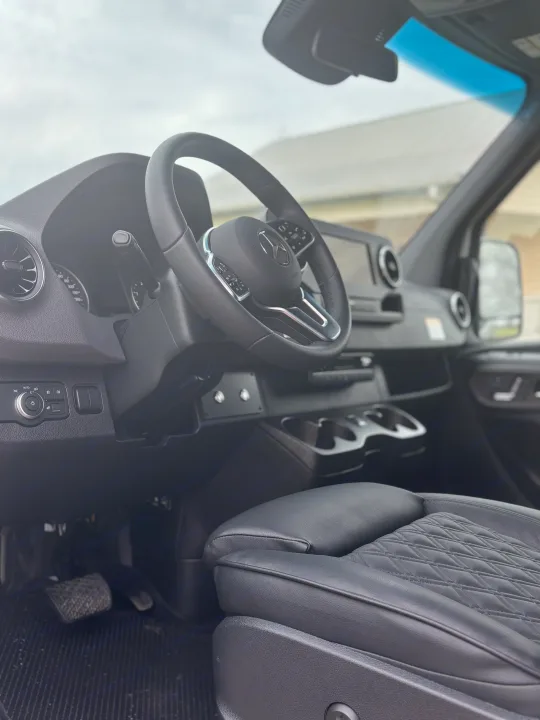 Step inside this RV rental! View of a modern Mercedes-Benz van interior: steering wheel, dash, and driver's seat.. Mercedes-Benz OG Luxury Coach V Cruis 2025
