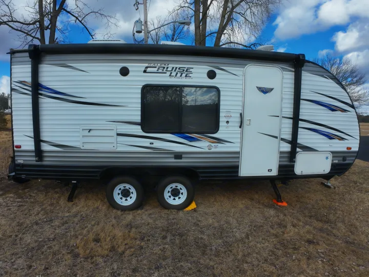 A white travel trailer, perfect for an RV rental, is parked on dry grass under a bright blue sky.. Forest River Salem Cruise Lite 2018