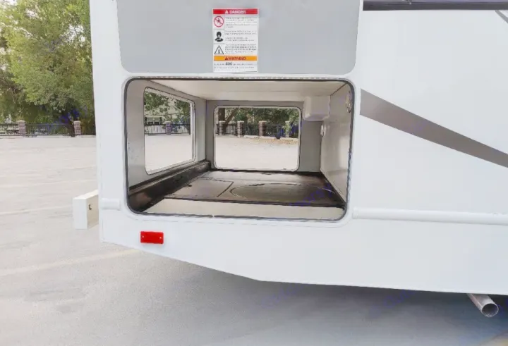 Spacious pass-through storage in an RV rental, showing the empty bay from one side to the other.. Thor Majestic 2016