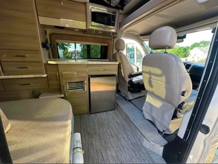 Step inside this RV rental, featuring a compact kitchenette, bed, & swivel front seats. Ready for your road trip!. Thor Motor Coach 18T 2022