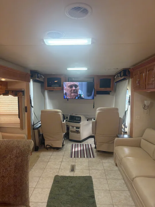 Spacious RV rental interior featuring the driver's area, comfortable seating, and a TV for an enjoyable journey.. Kountry Star Kountry Star Motorhome 2008