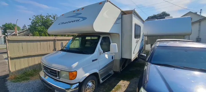White Chateau Class C RV motorhome with its slide-out extended, ready for an RV rental adventure.. Four Winds Chateau 2007