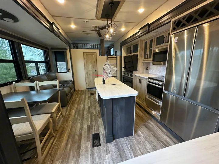 This inviting RV rental boasts a bright, spacious interior with a full kitchen, dining, and cozy living area.. Keystone RV Avalanche 2023