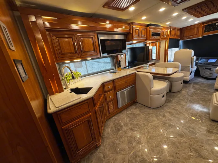 Step inside this premium RV rental: spacious kitchen, dining booth, and luxurious cabin design.. New Aire New Aire Motorhome 2020
