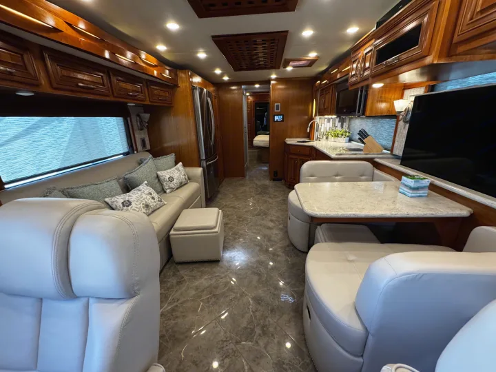 Spacious luxury RV rental interior featuring a well-appointed kitchen, comfortable living area, and dining nook.. New Aire New Aire Motorhome 2020