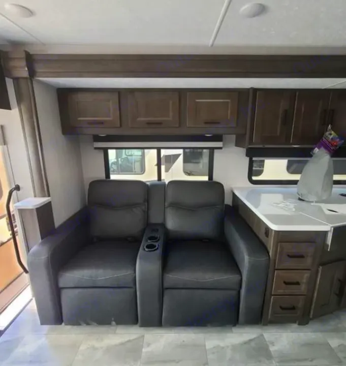RV rental: Spacious interior featuring comfy recliners, ample cabinets, and a functional countertop.. Coachmen Mirada 2024