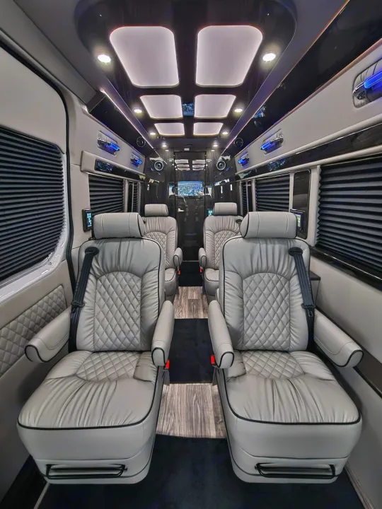 This luxury RV rental's interior boasts quilted grey captain's chairs, custom ceiling lights, and ample space for travel.. Ultimate Toys Ultimate Coach 2026