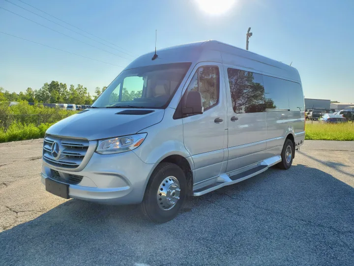 Silver Mercedes-Benz Sprinter camper van, an RV rental. Sunny day, parked on asphalt.. Ultimate Toys Ultimate Coach 2026
