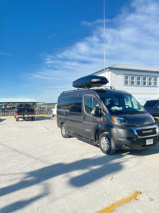 Black RV rental van with roof box parked at Edisto Watersports, near bike rentals. Ready for outdoor adventures.. Pleasure-Way Pleasure-Way Class B 2022