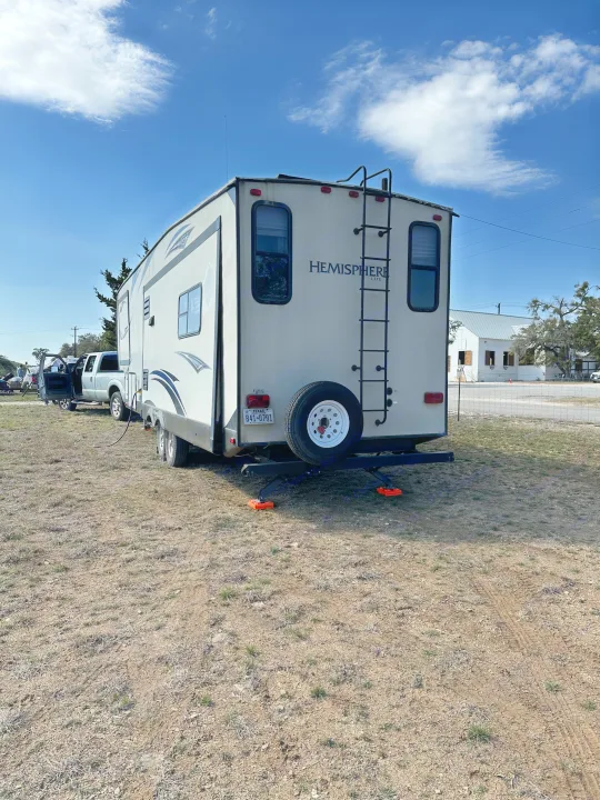 Hemisphere Lite rv rental from Texas, parked in a sunny, dry field, ready for a travel adventure.. Forest River Salem Hemisphere Lite 2015
