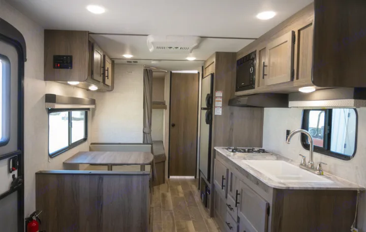 Spacious RV rental interior with kitchenette, dinette, and bunk beds, perfect for family adventures.. Gulf Stream 248BH 2022