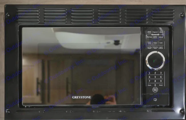 Modern Greystone microwave, a key kitchen appliance for any RV rental, featuring a black design and full control panel.. Gulf Stream 248BH 2022