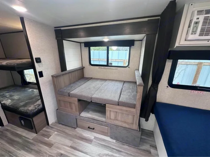 RV rental interior: A bunk bed setup and a convertible dinette offer sleeping for multiple guests in this cozy camper.. Jayco Jay Flight SLX 2024