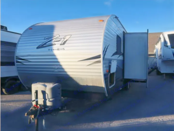 Front view of a silver Z-1 travel trailer with its slide-out extended, perfect for an rv rental.. Crossroads RV Z-1 2015