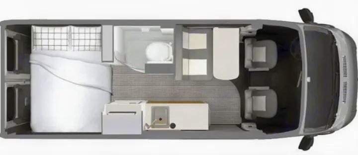 RV rental floor plan: A compact camper van interior, showing bed, kitchen, bathroom, and front cabin seats from above.. Airstream Rangeline 2024