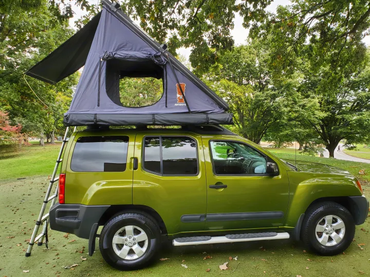 This lime green Nissan Xterra SUV with a rooftop tent is perfect for your next camping adventure, an excellent RV rental choice.. Nissan XTerra 2012