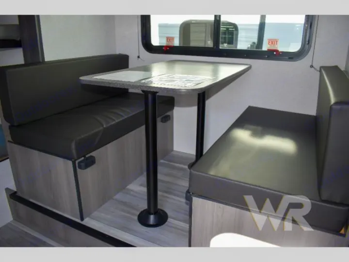 RV rental dinette: two cushioned benches and a central table for comfortable seating and dining inside the RV.. Keystone RV Hideout Sport 2024