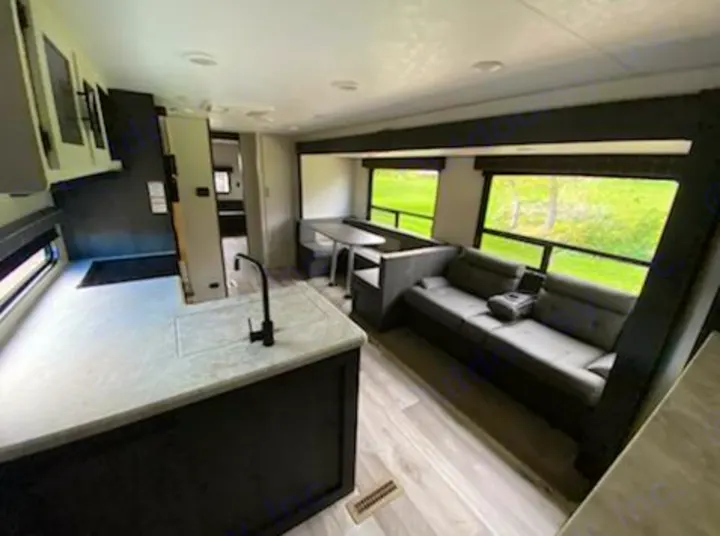Modern RV rental interior featuring a full kitchen, dinette, and comfy sofa with large scenic windows.. KZ 332BHKSE 2022