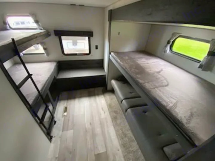 Spacious RV rental bunk room features triple bunks, sofa, and bench seating. Perfect for family adventures.. KZ 332BHKSE 2022