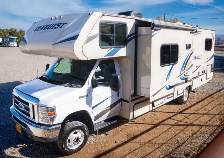 This white and beige Gulf Stream Conquest Class C RV rental, with an extended slide-out, is ready for your adventure.. Gulf Stream Conquest 2019